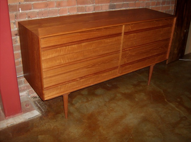 Spectacular Mid-century teak 6 drawer dresser - lovely dovetailed drawers - unique detail around the tapered legs - quality craftsmanship - note - bottom left corner has a chip that has been repaired - (SOLD)