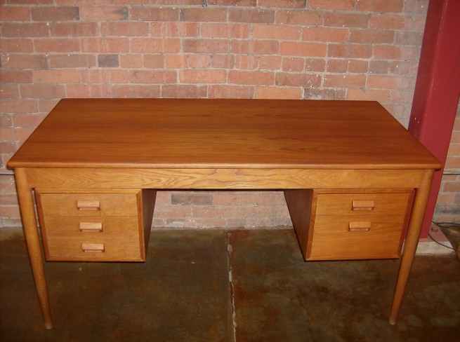 A Classic 1950's desk designed by Borge Mogensen for Soborg - Denmark - teak top/drawers with contrasting oak legs and banding - very good vintage condition - a couple small burn marks on top - overall gorgeous piece - measures - 57"L x 28.5"D x 29"H - (SOLD)