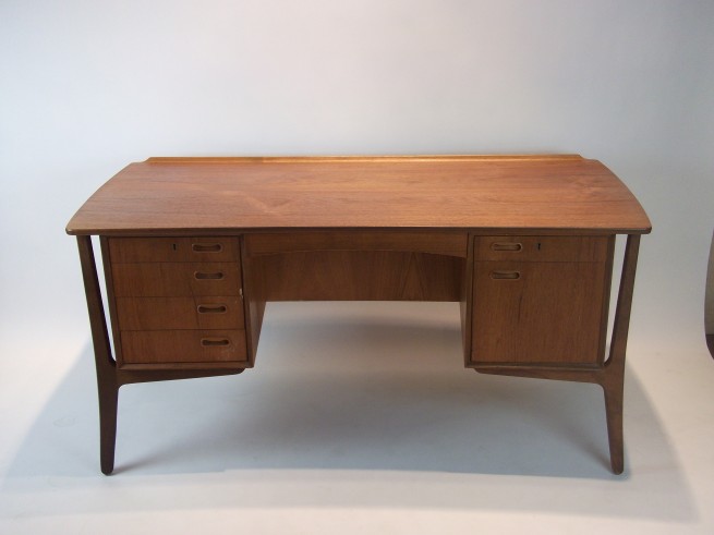 Exceptional Mid-century teak desk designed by Architect Svend Aage Madsen for H.P.Hansen - made in Denmark - outstanding design and craftsmanship - finished back with bookshelf and locking cabinet - comes with original key in working order - lovely patina - very good vintage condition with a small exception of a few small chips in the solid wood dovetailed drawers - this beauty measures - 60"L x 29"D x 28.5"H - $2000