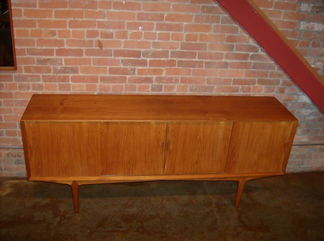 Stunning Mid-century modern teak credenza by Knud Nielsen - Denmark - fantastic quality - unique base - check out the legs - - very good condition - lovely patina and grain pattern - 3 small dovetailed drawers on the left - no shelves on the inside -this beauty measures - 78.5"L x 18"D x 33"H - $1450