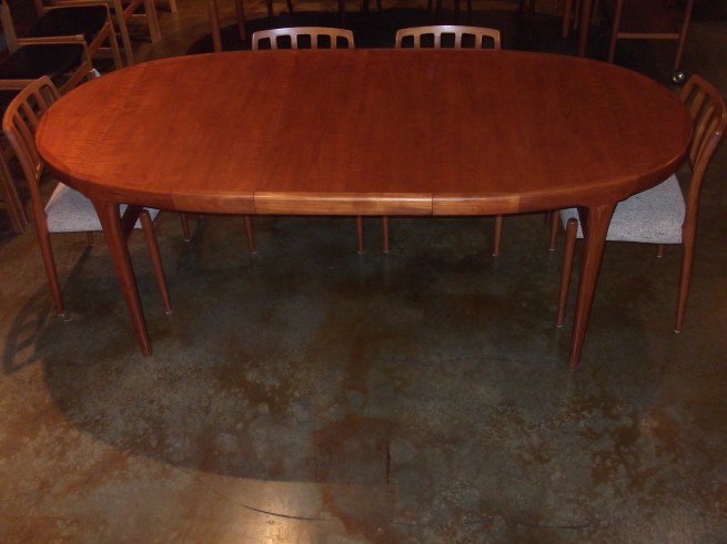 Exceptional teak dining table designed by IB Kofod Larsen made in Denmark in the 1960's measures 67.5" L X 42" D X 29.5" H as shown with its 20.75" leaf (SOLD)