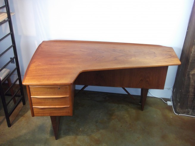 Exceptional 1950's teak desk designed by Peter Lovig Neilsen - made in Denmark - incredible quality - attention to detail - finished back w/bookcase and secret liquor cabinet - dovetailed drawers - lovely brass & teak stretchers - newly re-finished top - very good vintage condition - comes with original key for the front drawer and back cabinet - this beauty measures - 59"L x 35"Widest depth x 29'H - $1800