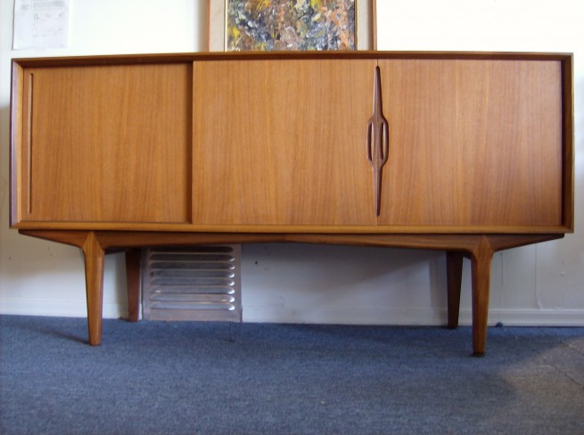 Extraordinary 1960's Danish teak credenza - incredible design with superb craftsmanship - stunning carved handles - solid teak top and sides - lovely dovetailed rosewood drawers inside - please ask for more photos - excellent condition - Danish modern at it's best - 63"L x 18"D x 33"H - $995