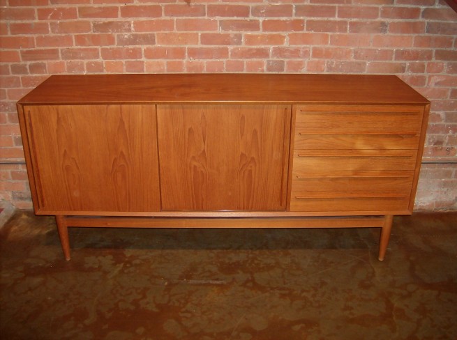 Gorgeous Mid-century teak credenza - made in Denmark by H.P Hansen - incredible craftsmanship - incredible sculpted handles - gorgeous dovetailed drawers - stunning even patina and grain - excellent condition - this beauty measures - 71"L x 19.75"D x 33.25"H -(SOLD)